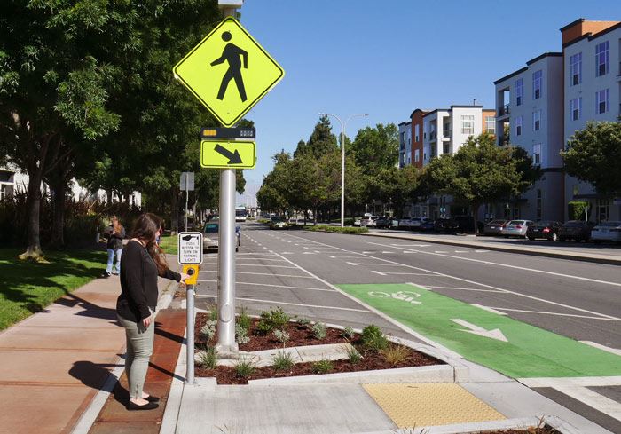 photo example of a rectangular rapid flashing beacon to alert motorists that pedestrians are using the crosswalk.