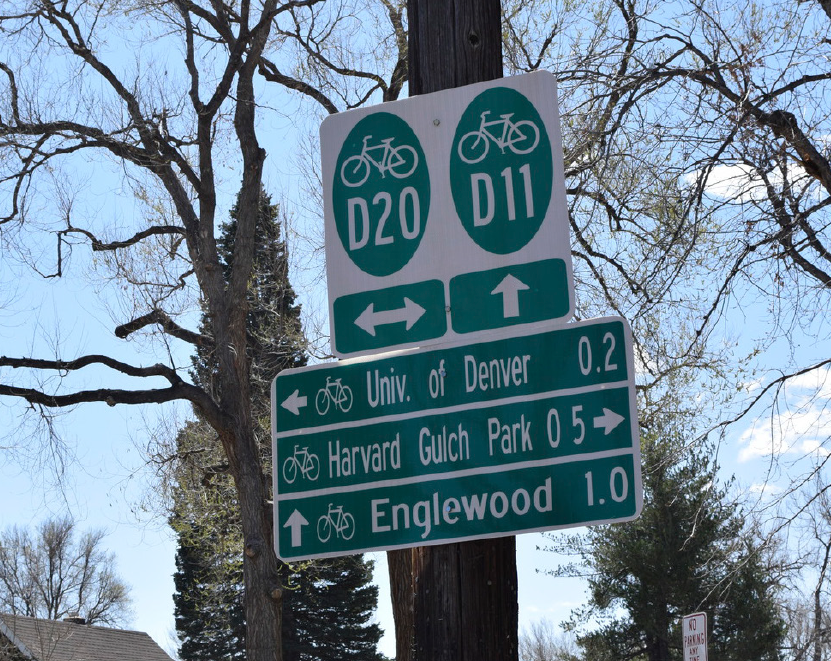 Photo of wayfinding signage example showing bike path D20 and D11 connecting paths along Buchtel Boulevard as a more pleasant and easily navigated street.